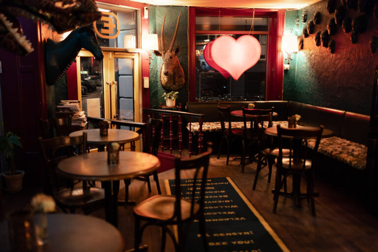 Inside Café Bankeråt with a red neon heart in the window and green walls